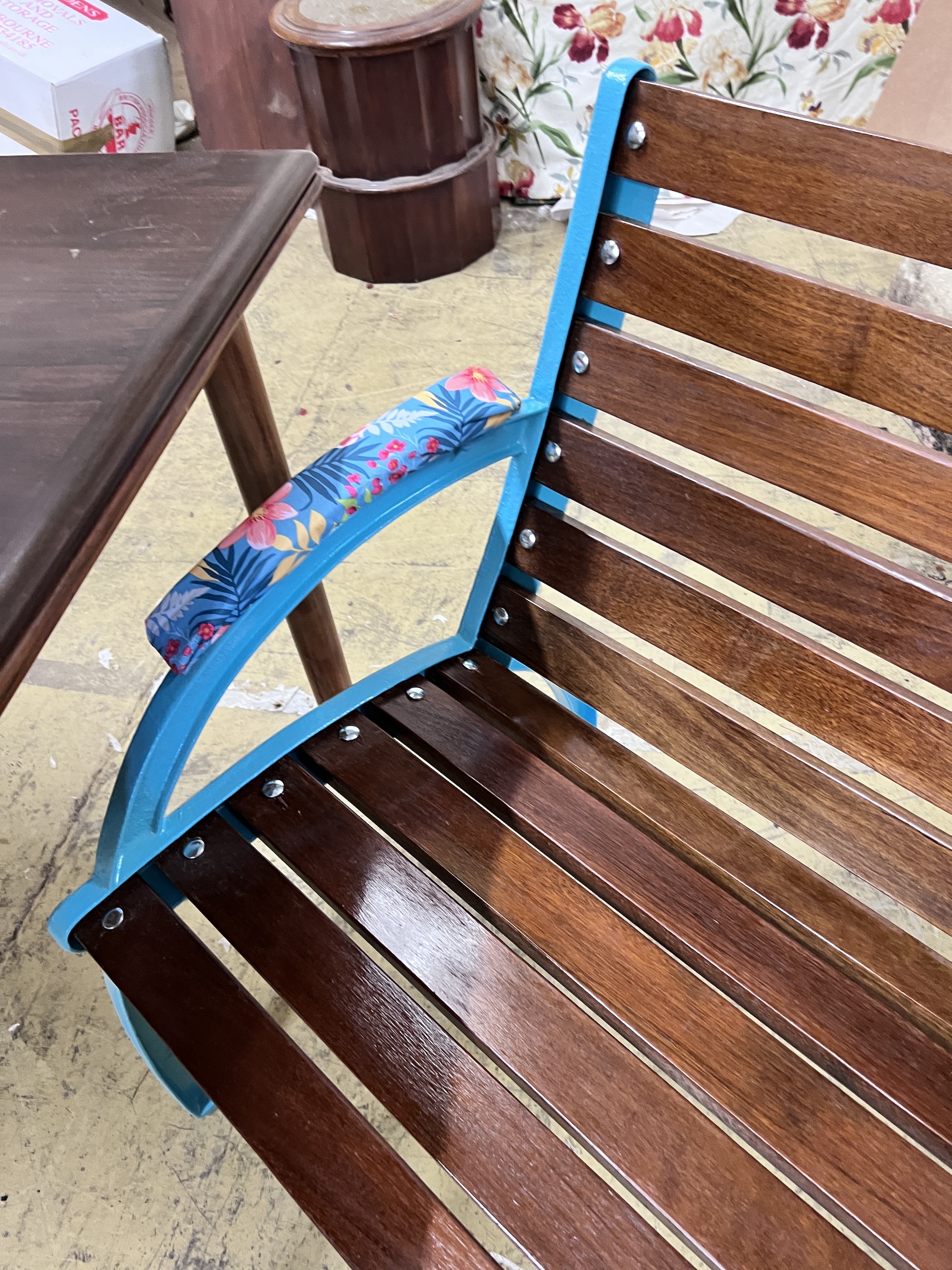 A teak and cast iron garden bench, length 127cm